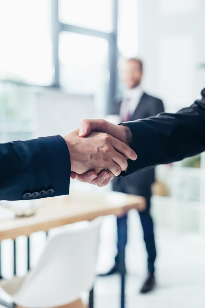 close-up partial view of businessmen shaking hands