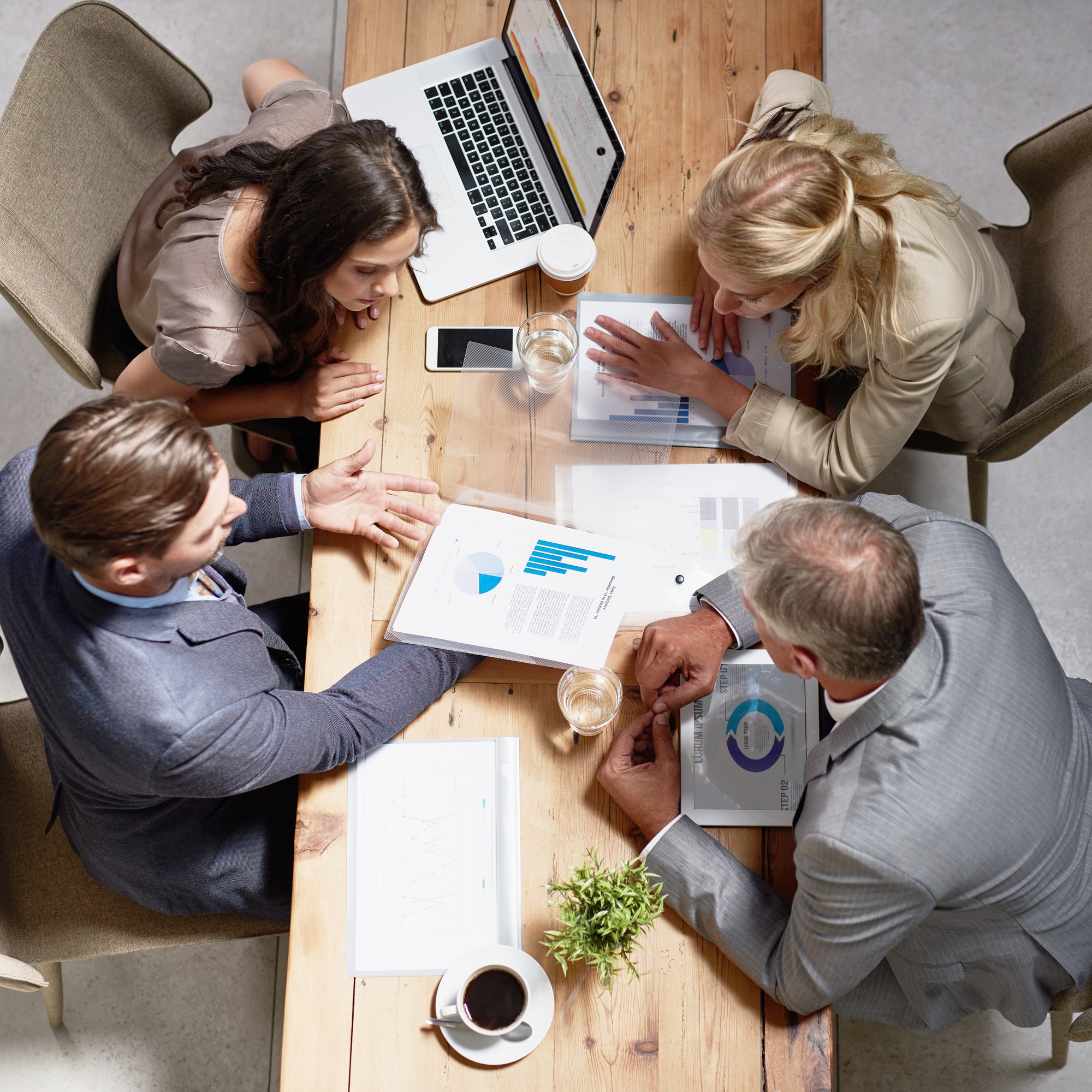 High angle shot of a group of businesspeople having a discussion in an office