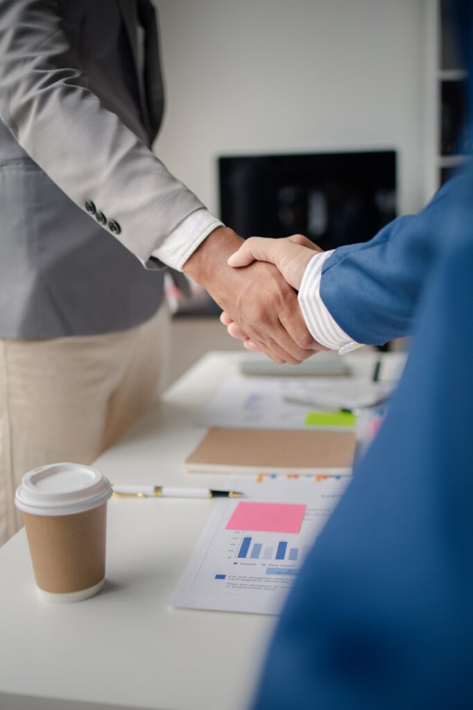 Two business men shake hands, Two businessmen are agreeing on business together and shaking hands af